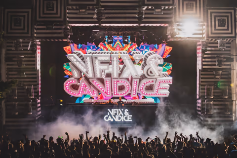 NFIX & CANDICE stage graphics above a crowd and smoke effects